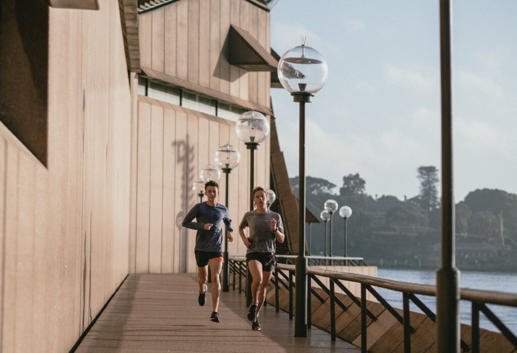 Take the first step into your fitness journey today - runners on a bridge